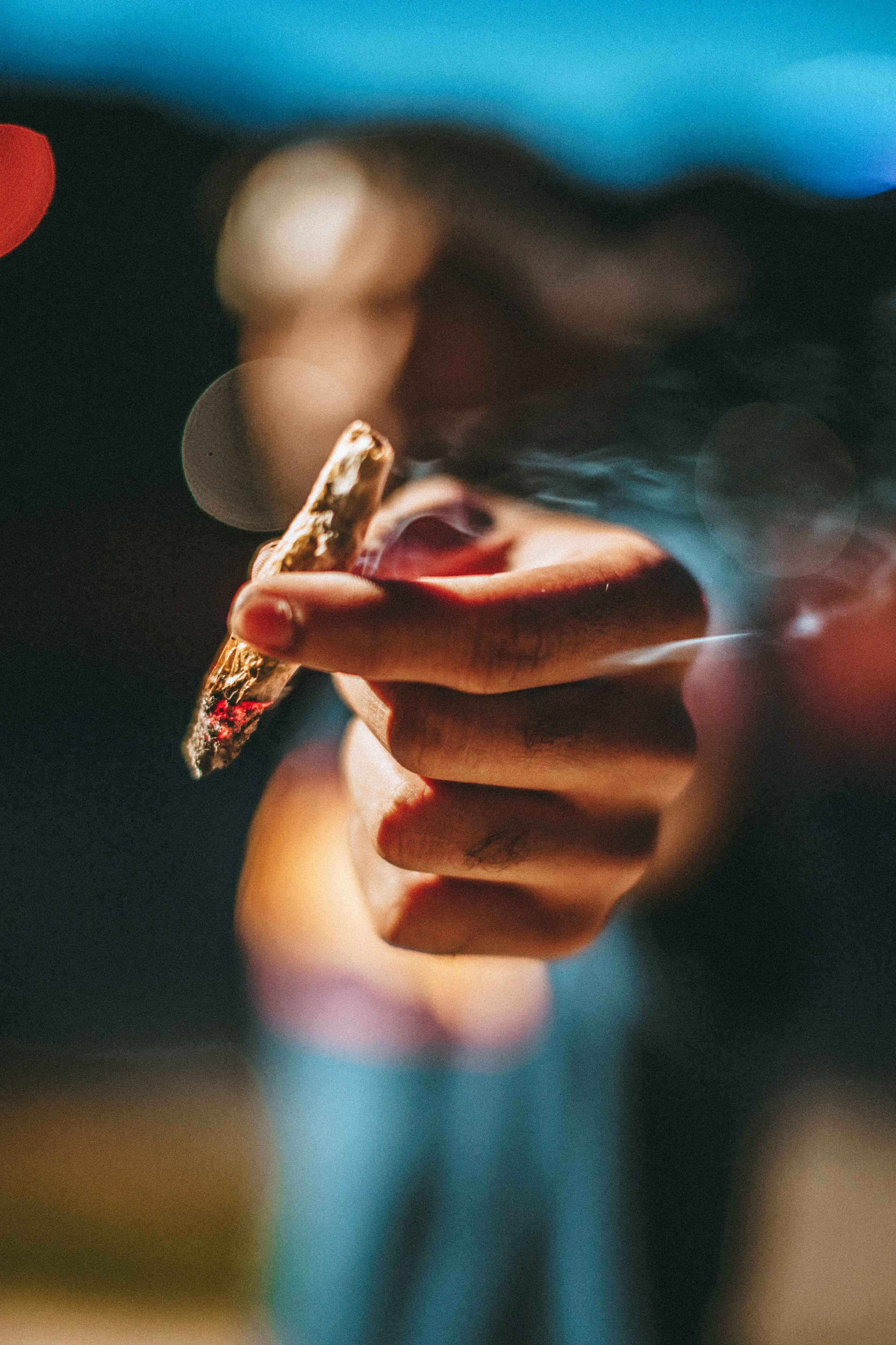 Hand offers you a joint (photo by Chase Fade)
